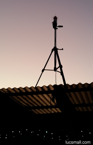 "A 16 radial spider antenna for ADSB mounted on a tripod, at sunset"